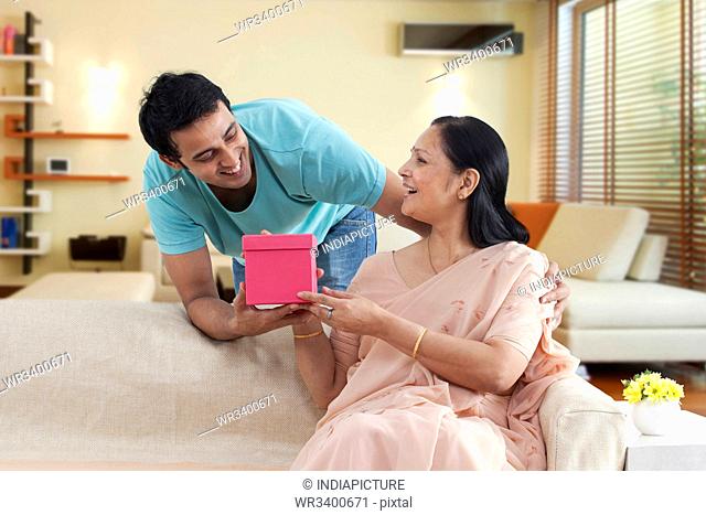 Mother and son exchanging gift