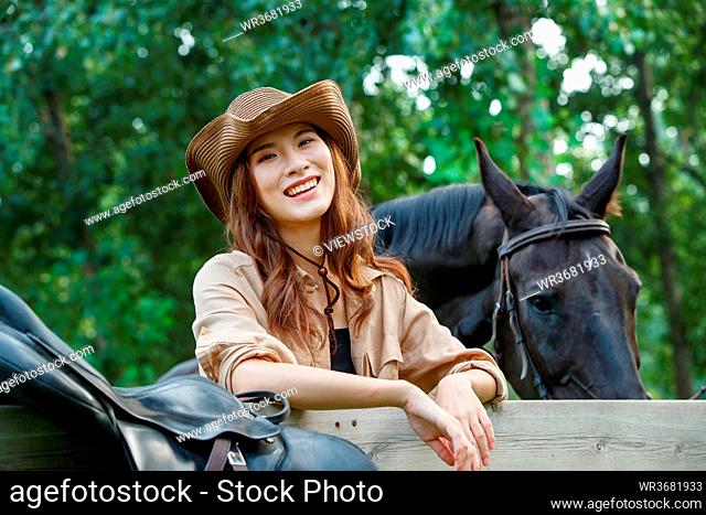 Happy young women and horses