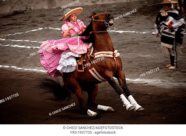 A escaramuza rides her horse before competing in an Escaramuza in the Lienzo Charros del Pedregal, Mexico City, Sunday, March16, 2013
