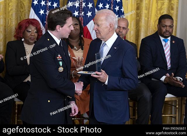 United States President Joe Biden presents the Presidential Citizens Medal to Washington DC Metropolitan Police Department officer Daniel Hodges during a...
