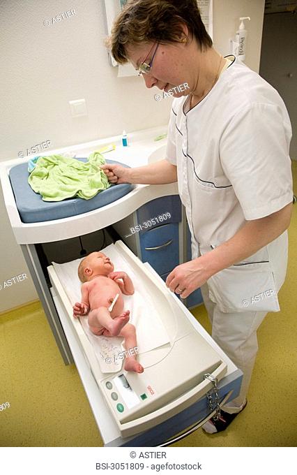 Photo essay at the maternity of Saint-Vincent de Paul hospital, Lille, France. Monitoring of the weight during the washing of the newborn baby