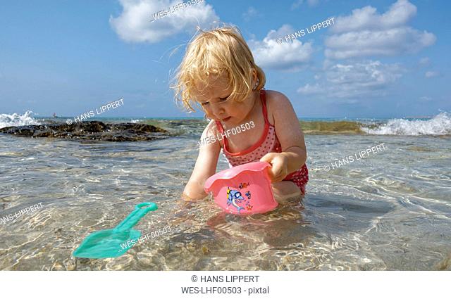 Little girl playing in the sea
