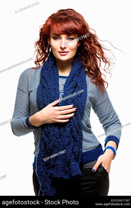 Young beautiful woman with long knitted blue wool scarf
