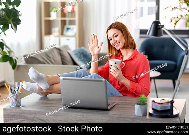 woman with laptop having video call at home office