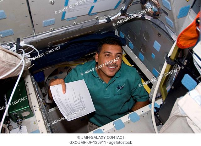NASA astronaut Jose Hernandez, STS-128 mission specialist, is pictured in the hatch which connects the flight deck and middeck of Space Shuttle Discovery while...