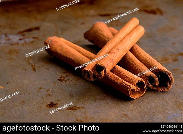 brown healthy cinnamon sticks spice on steel plate