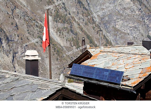 Roofs Walliser timber houses with solar reflectors in the hamlet Tuftern, Zermatt, Switzerland