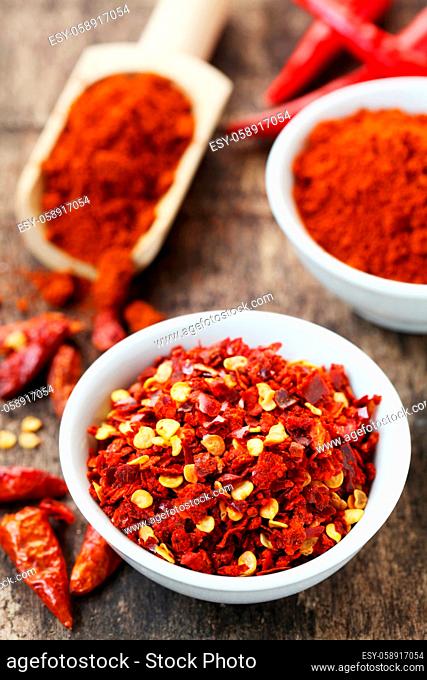 Dried And Ground Chillies On A Wooden Background
