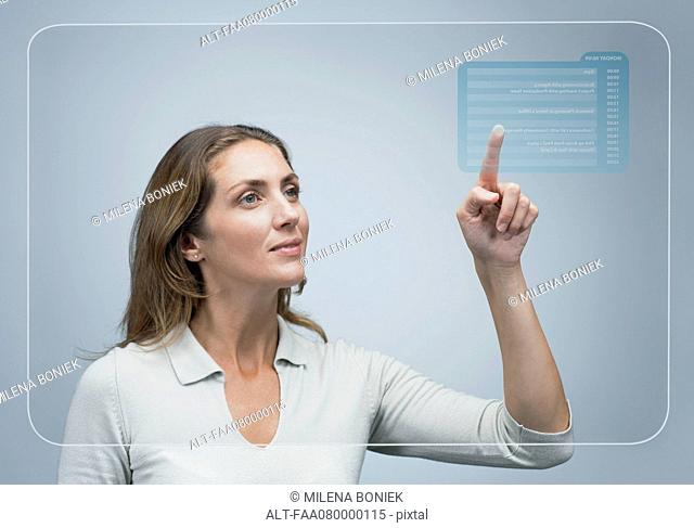 Woman looking at her schedule of the day on advanced touch screen interface