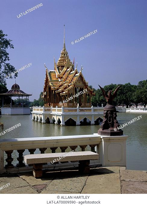 The Aisawan Thippaya Pavilion on the Choa Phraya river. A gilded curved roof on the Royal Palace building