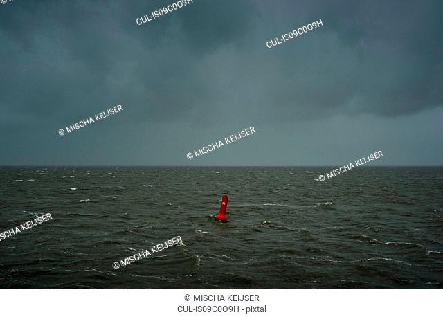 Seascape with heavy rain and hail over the Waddensea in winter, Hollum, Friesland, Netherlands