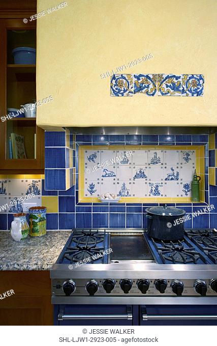 Tile: Detail of kitchen stove area with exhaust hood. Decorative use of ceramic tile. Yellow and blue tiles frame inset of blue and white hand painted tile