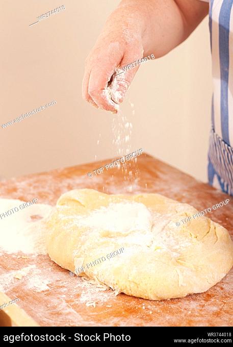 Baking biscuits, woman kneading the dough