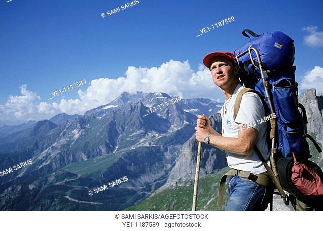 Male hiker contemplating a mountainous landscape
