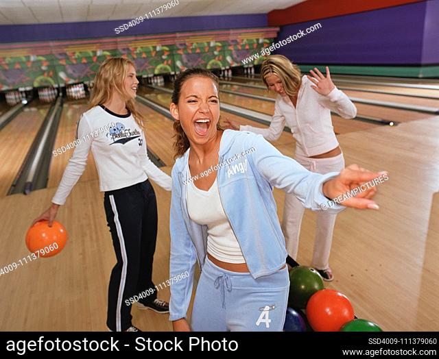 Young women laughing at bowling alley