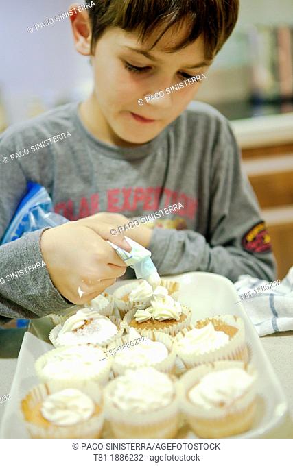 Boy making cupcakes
