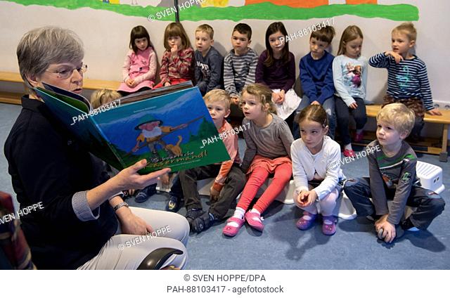 The teacher Erika Marschall reads to children from a book at the kindergarten St. Franz Xaver in Munich, Germany, 19 January 2017