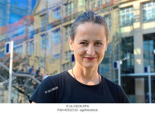 Choreographer Sasha Waltz smiles as she stands in front of trhe entrance area to the Zentrum für Kunst und Medientechnologie (ZKM)