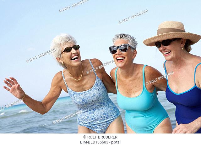 Senior women walking on beach