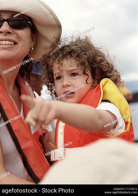 Mother and young daughter wearing life-jackets