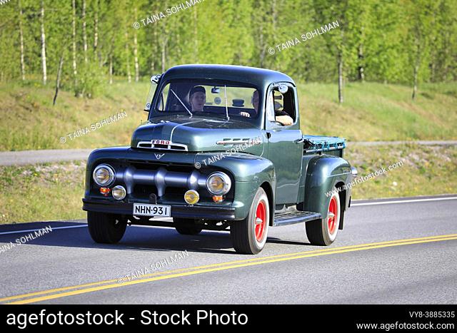 Beautiful green Ford F1 V8 pickup truck, early 1950s, and people enjoying the ride on Salon Maisema Cruising 2019. Salo, Finland. May 18, 2019