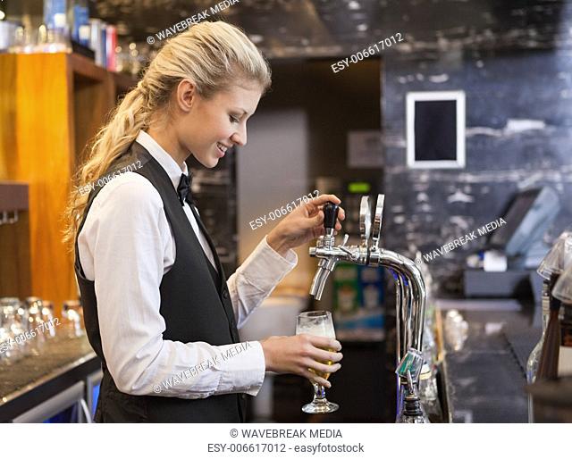 Barmaid pulling a glass of beer