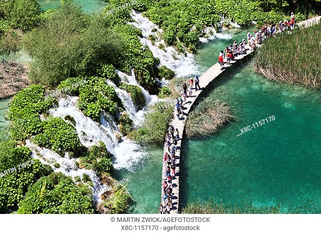 The Plitvice Lakes in the National Park Plitvicka Jezera in Croatia  Visitors on the plank paths of the national Park  The Plitvice Lakes are a string of lakes...