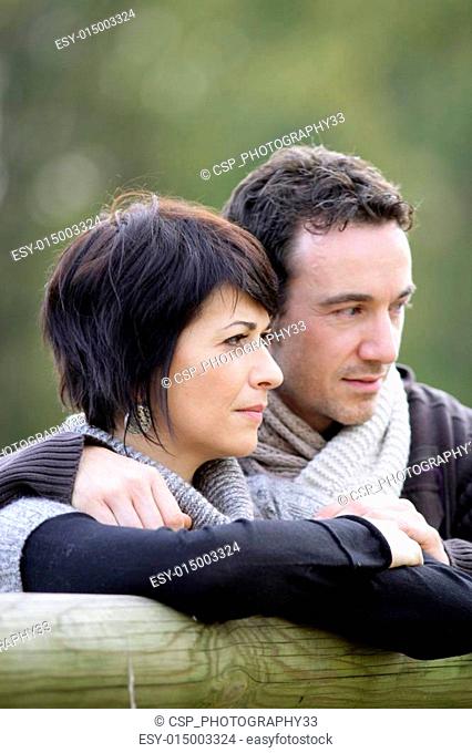 Couple stood by fence