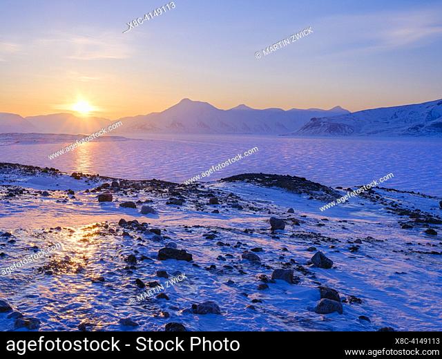 View over frozen Adolfbukta and Billefjorden near Nordenskioeldbreen towards Pyramiden ghost town. Winter landscape on the island Spitsbergen in the Svalbard...