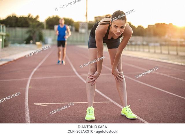 Woman leaning forward on racing track