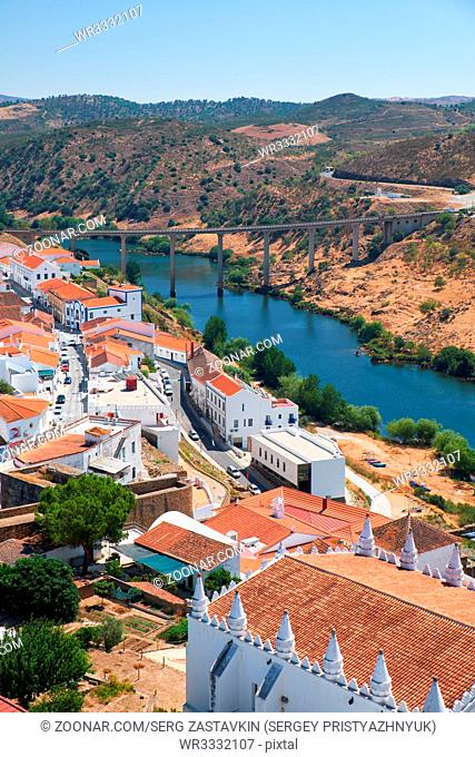 The view of Mertola city on the riverside of Guadiana with the bridge over the river on the background. Baixo Alentejo. Portugal
