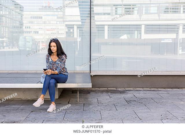 Mature woman using smartphone outdoors