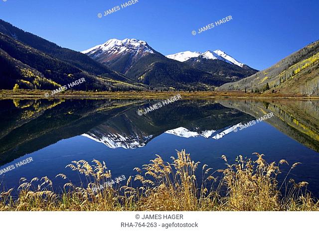Snow-capped Red Mountain reflected in Crystal Lake with fall colors, near Ouray, Colorado, United States of America, North America