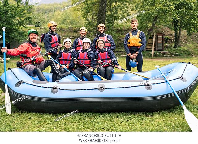 Instructor and group of friends at a rafting class posing in boat