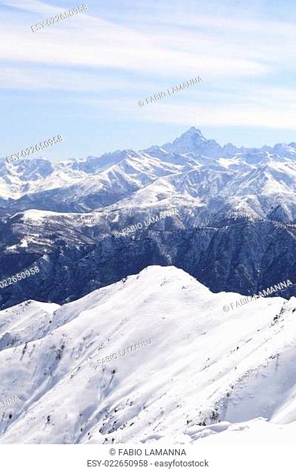 Off piste snowy slope in majestic high mountain frozen scenery and infinite view, winter in the italian Alps
