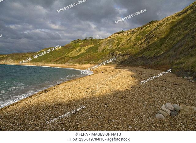 View of small coastal bay on windy morning, with house on clifftop, Ringstead, Dorset, England, october