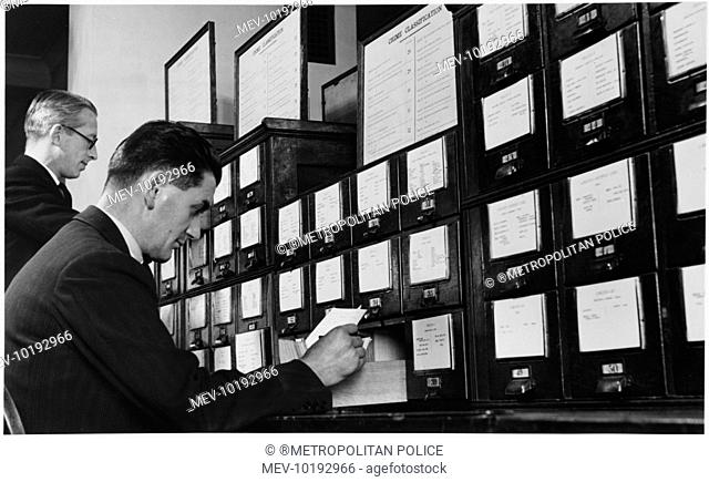 Researching records in the New Scotland Yard Criminal Record Office crime classification card indexing files. Metropolitan Police