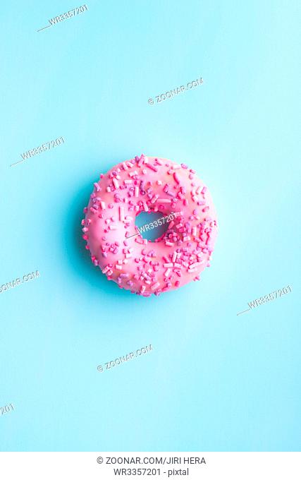 One pink donut on blue background