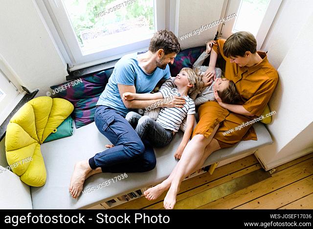 Parents spending leisure time with son and daughter at home
