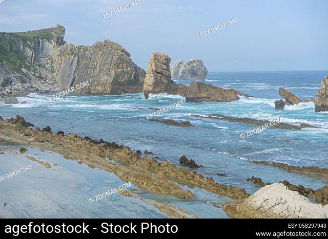 Rocks on the beach. Dramatic view of Playa de la Arnia, rocky coastline in Santander , Cantabria, Spain