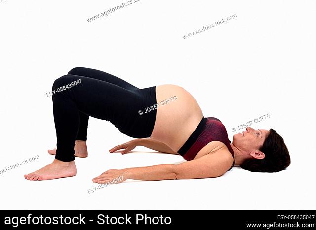 pregnant woman doing exercises on white background