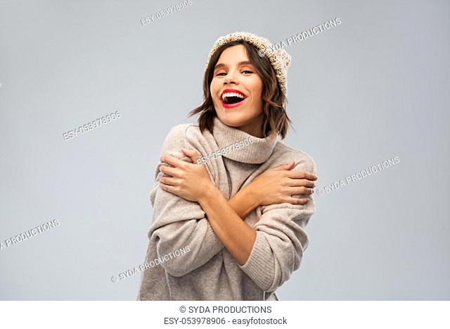 young woman in knitted winter hat and sweater