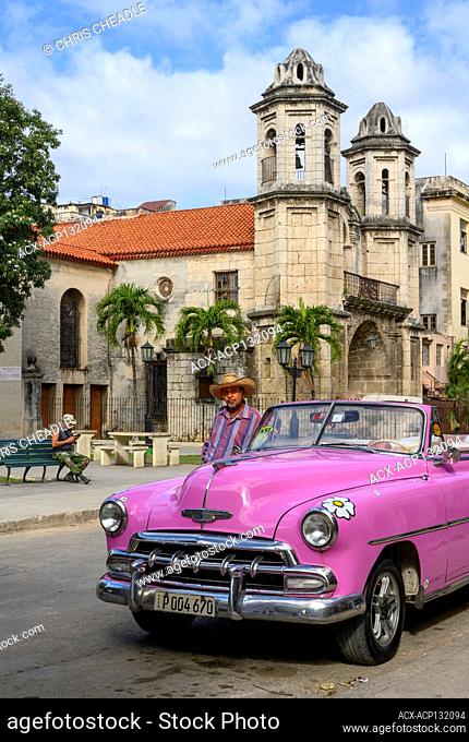 Classic car in pink at Iglesia del Santo Cristo del Buen Viaje, is located in Havana Vieja, Havana, Cuba