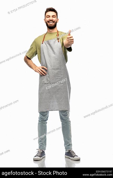 happy smiling barman in apron showing thumbs up