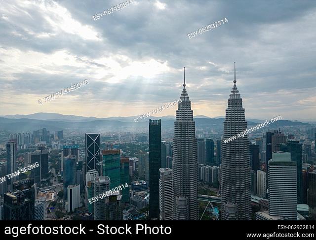 Bukit Bintang, Kuala Lumpur, Malaysia - Dec 25 2022: The city's iconic landmarks the Petronas Twin Towers in sun ray morning