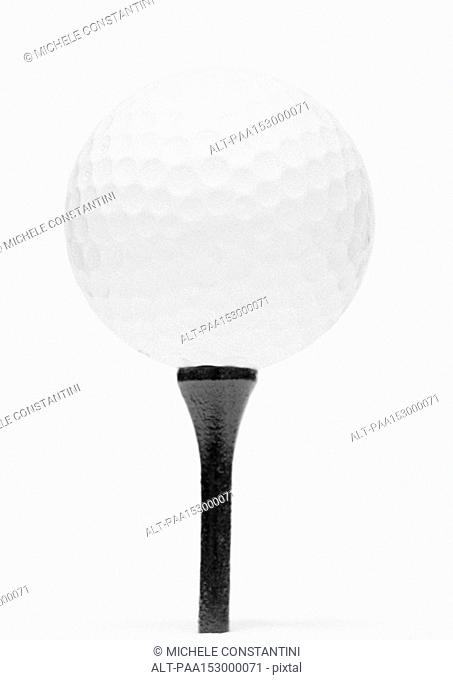 Golf ball and tee, close-up, b&w