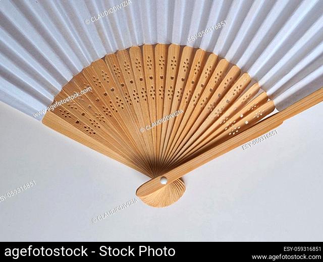 traditional japanese or chinese hand fan made of paper and wood