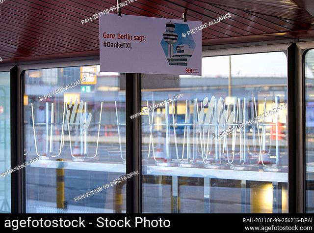 08 November 2020, Berlin: A poster ""All of Berlin says: #DankeTXL"" is hung up at the entrance to Tegel Airport. Behind the glass panel you can see the raised...