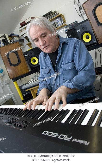 Rick Lloyd, former member of the British 80's band the Flying Pickets playing keyboard in his home studio in Cwm Ystwyth village near Aberystwyth, Wales, UK