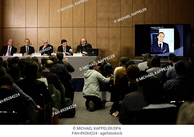 Guenter Lubitz (2nd l), father of the Germanwings co-pilot of the plane crash in the Alps, participates in a press conference while a photo of his son Andreas...
